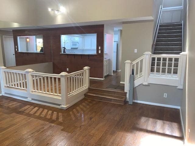 stairs featuring hardwood / wood-style flooring