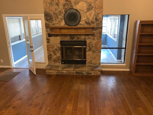 unfurnished living room with a fireplace and dark hardwood / wood-style floors