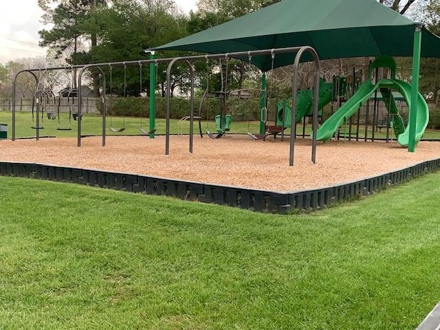 view of playground with a lawn