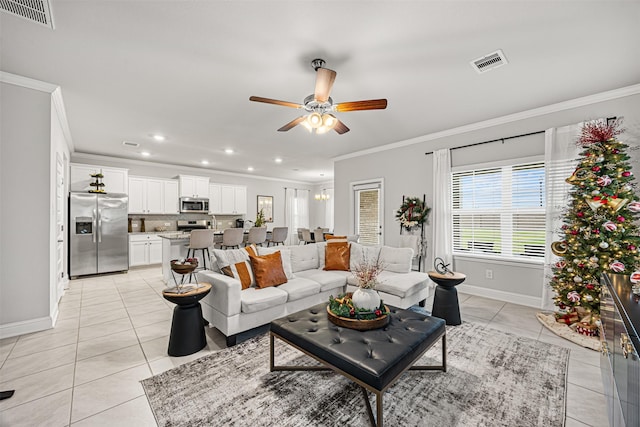 tiled living room featuring ceiling fan and crown molding