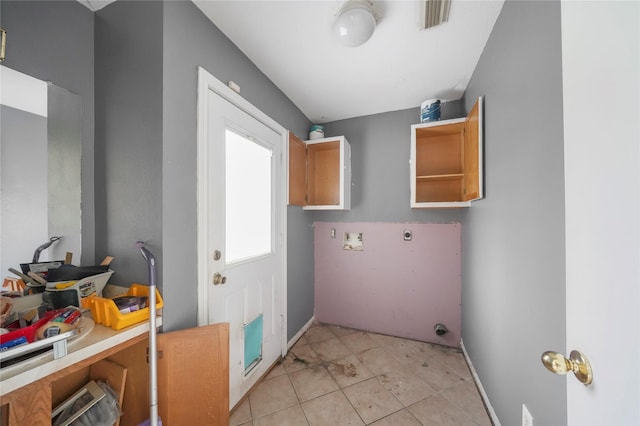 washroom with light tile patterned floors