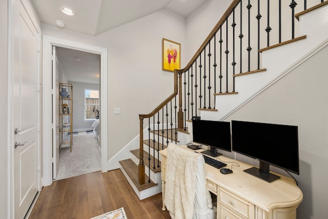 office area with dark hardwood / wood-style flooring, built in desk, and vaulted ceiling