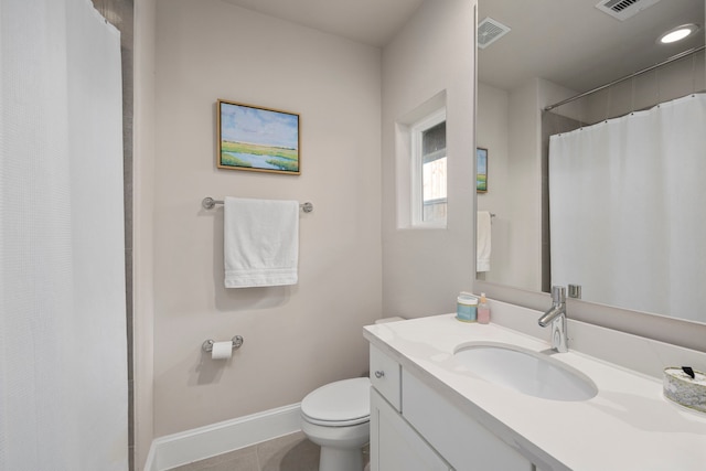 bathroom featuring tile patterned flooring, vanity, and toilet