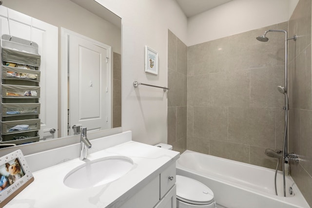 full bathroom with vanity, tiled shower / bath combo, and toilet