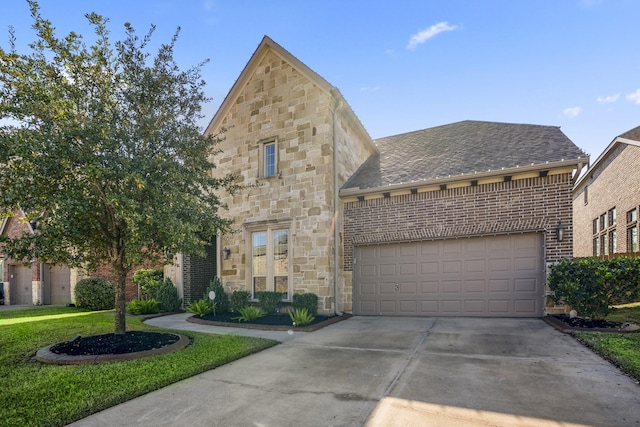 view of front of property featuring a garage and a front yard