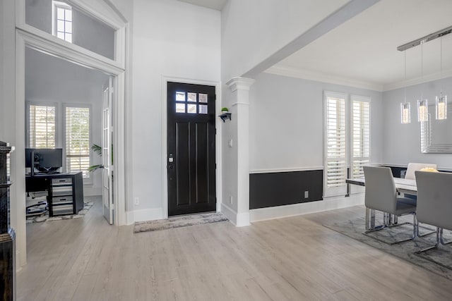 entryway featuring light hardwood / wood-style flooring and crown molding