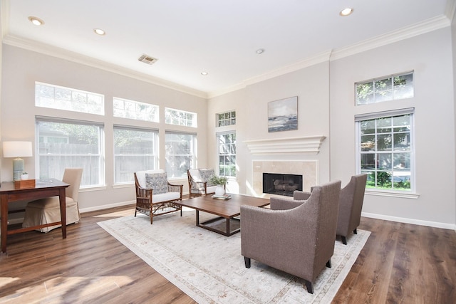 living room with hardwood / wood-style floors, plenty of natural light, and ornamental molding