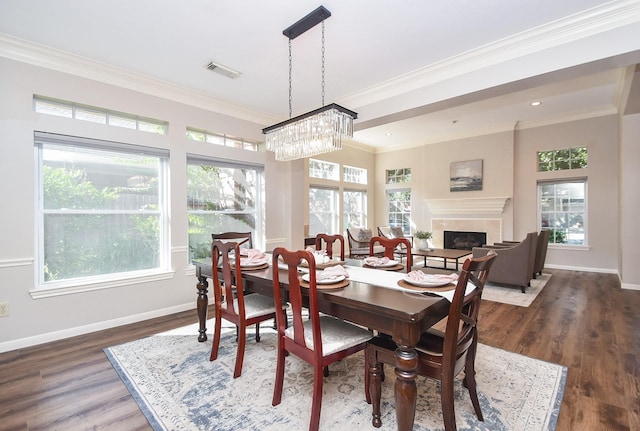 dining room featuring a chandelier, dark hardwood / wood-style floors, and ornamental molding