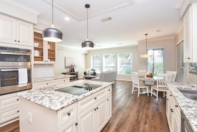 kitchen featuring light stone countertops, backsplash, stainless steel appliances, dark hardwood / wood-style floors, and a kitchen island