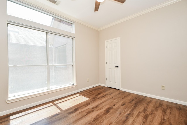 spare room featuring ceiling fan, dark hardwood / wood-style flooring, and crown molding