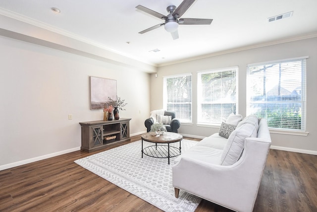 living room featuring ceiling fan, crown molding, and dark wood-type flooring