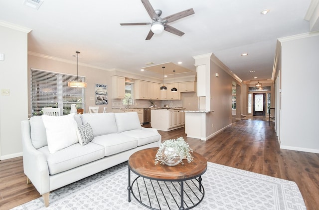 living room featuring hardwood / wood-style floors, plenty of natural light, and ornamental molding