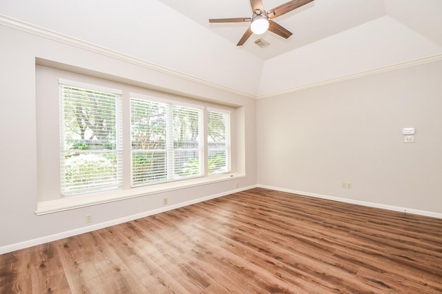 unfurnished room with hardwood / wood-style flooring, ceiling fan, a tray ceiling, and vaulted ceiling