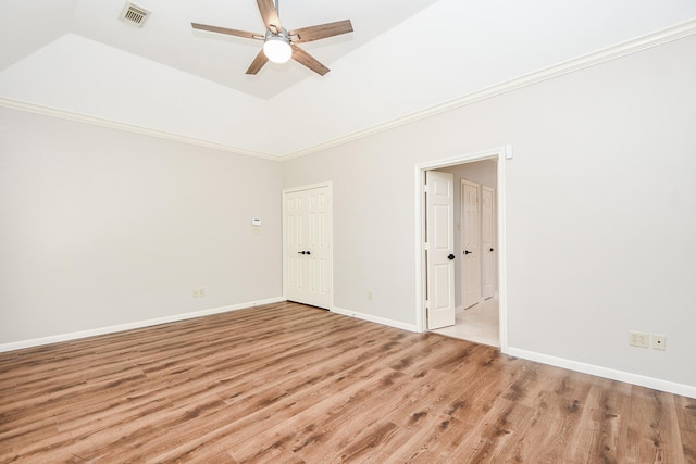 unfurnished room featuring ceiling fan, light wood-type flooring, crown molding, and a tray ceiling