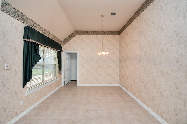 tiled spare room with vaulted ceiling and a notable chandelier