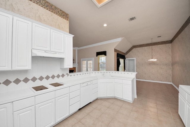 kitchen featuring dishwasher, white cabinetry, ornamental molding, decorative light fixtures, and kitchen peninsula