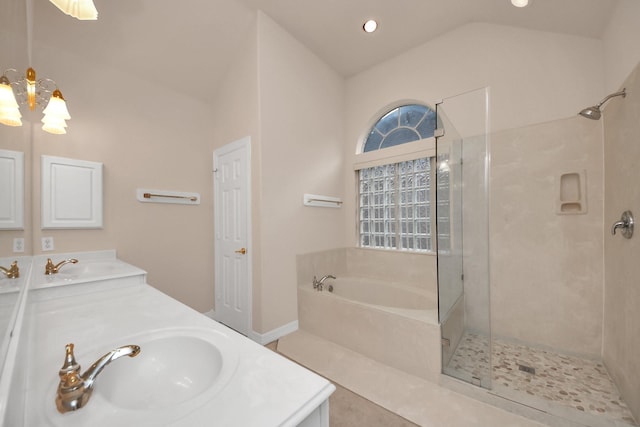 bathroom with vanity, vaulted ceiling, and independent shower and bath