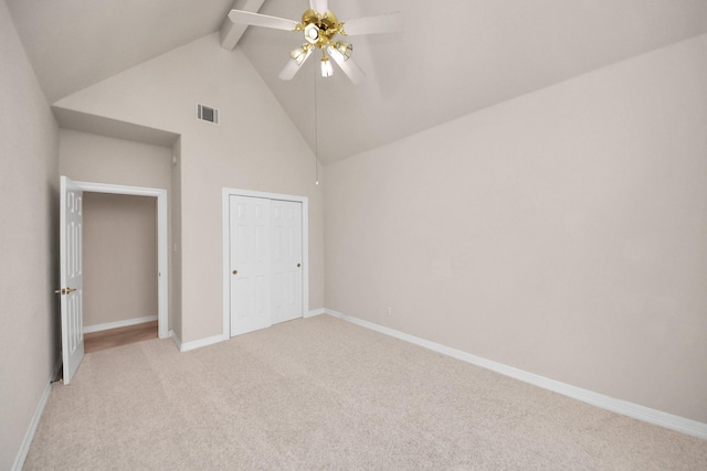 unfurnished bedroom with light carpet, ceiling fan, high vaulted ceiling, and beamed ceiling