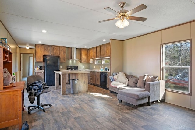 kitchen with dark hardwood / wood-style flooring, wall chimney exhaust hood, black appliances, a kitchen island, and a breakfast bar area