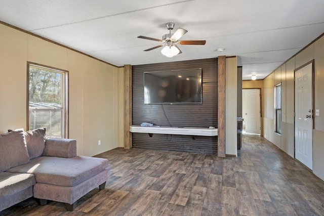 unfurnished living room with ceiling fan and dark hardwood / wood-style floors