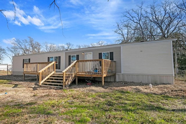 rear view of property featuring a deck