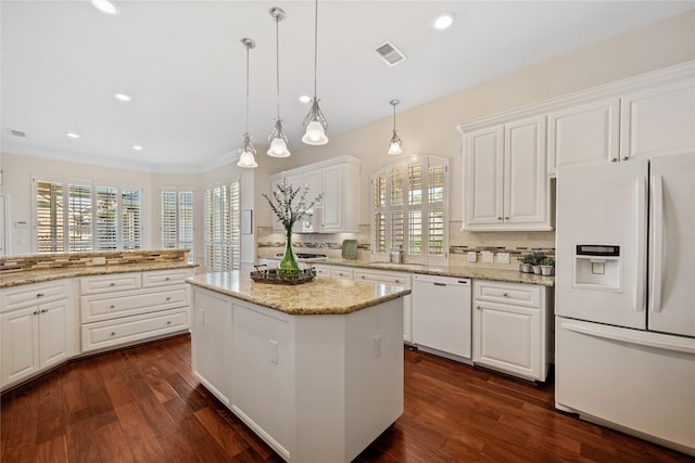 kitchen featuring white appliances, pendant lighting, a kitchen island, white cabinetry, and dark hardwood / wood-style floors