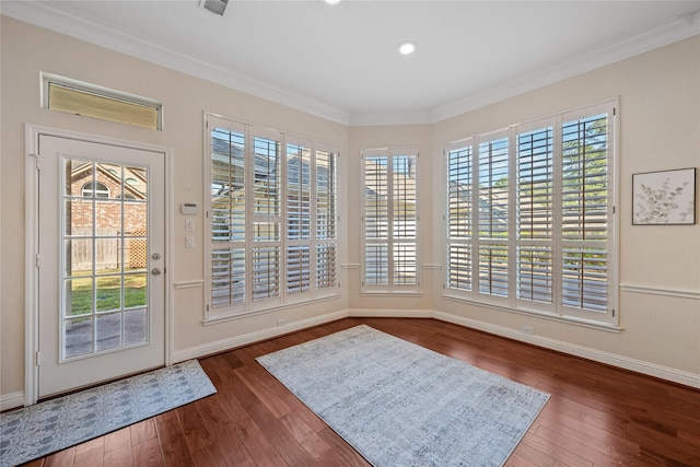 doorway to outside featuring dark wood-type flooring and crown molding