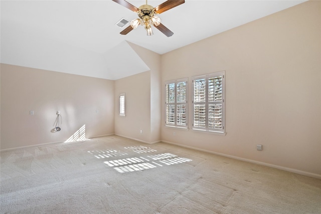 spare room with ceiling fan, a healthy amount of sunlight, and light colored carpet