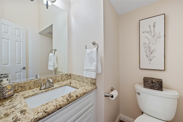 bathroom with toilet and vanity