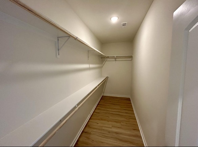 walk in closet featuring light hardwood / wood-style floors