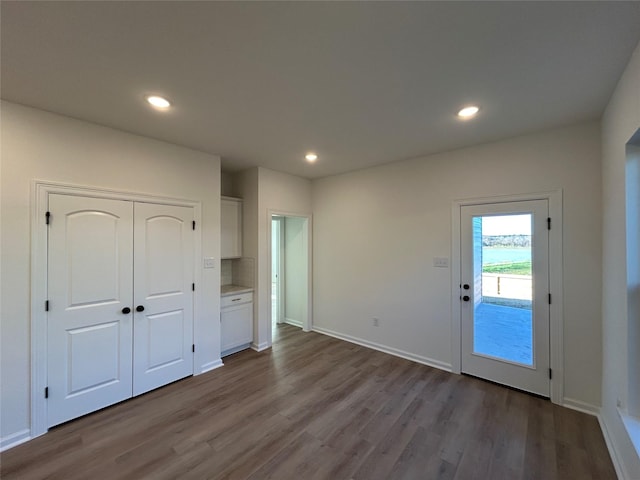 interior space featuring dark wood-style floors, baseboards, and recessed lighting