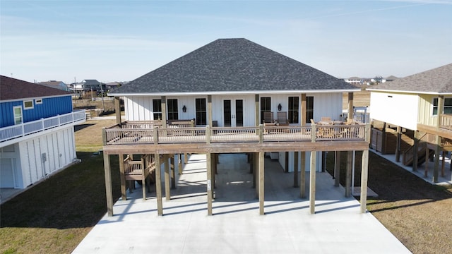 back of property with a wooden deck and a carport