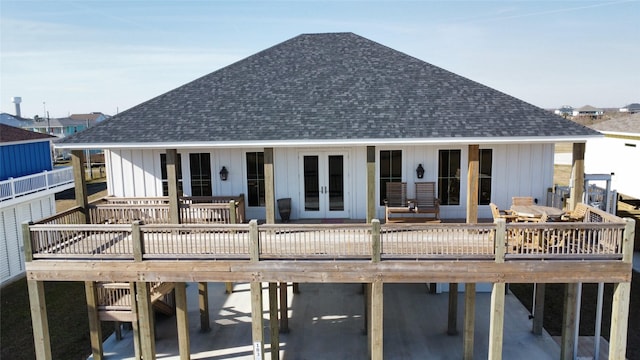 rear view of property with french doors and a deck