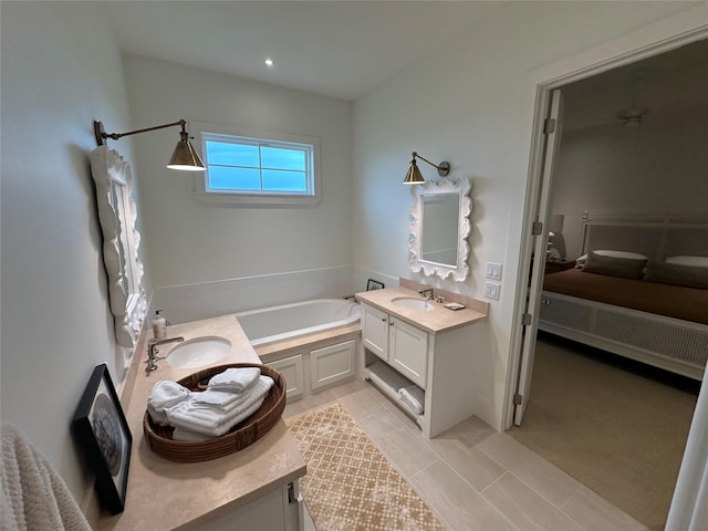 bathroom featuring tile patterned flooring, vanity, and a tub