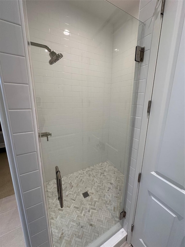 bathroom featuring a shower with door