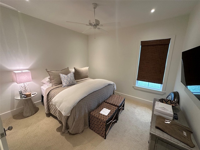 bedroom featuring ceiling fan and light carpet