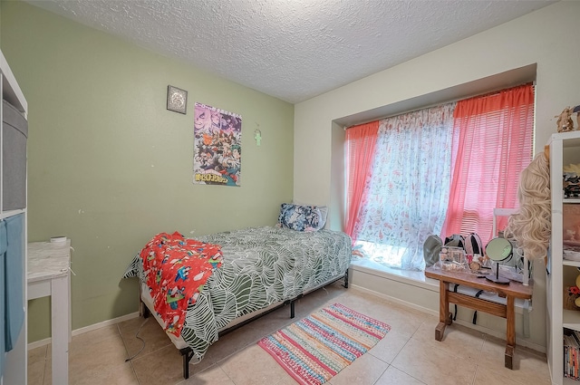 tiled bedroom with multiple windows and a textured ceiling