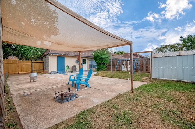 view of patio with a fire pit, a storage unit, and cooling unit