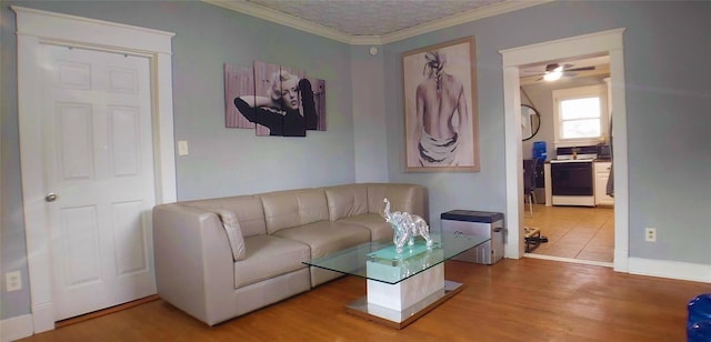 living room with ceiling fan, hardwood / wood-style floors, and crown molding