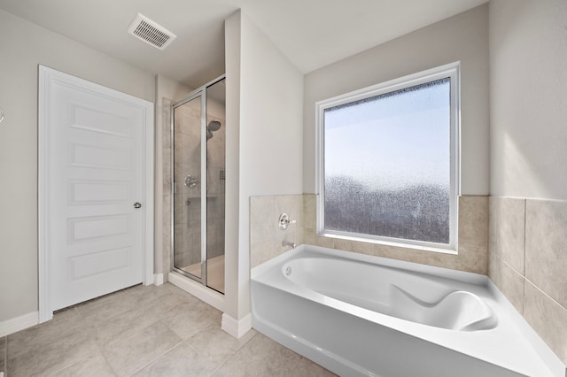 bathroom with separate shower and tub and tile patterned floors