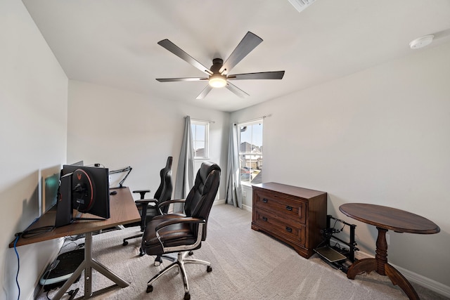 office space with light carpet and ceiling fan