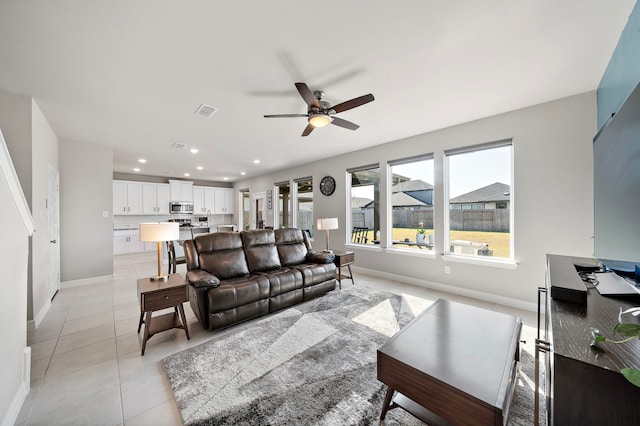 tiled living room featuring ceiling fan