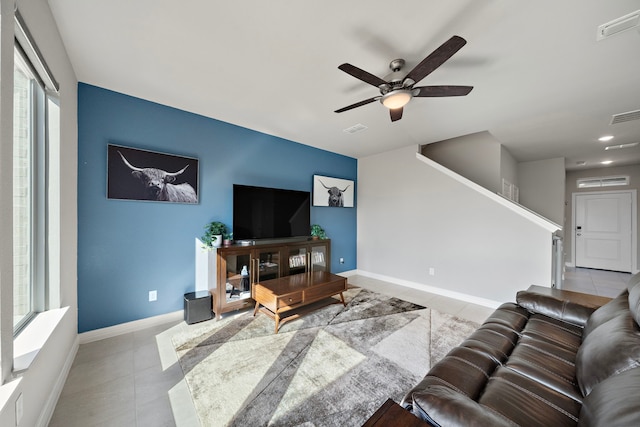 living room featuring ceiling fan and light tile patterned floors