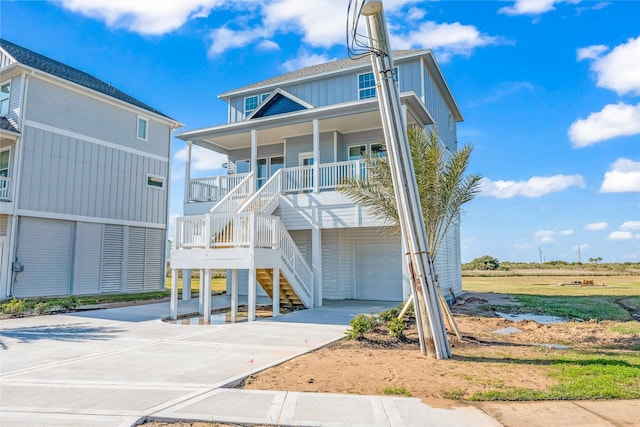 beach home featuring a porch and a garage