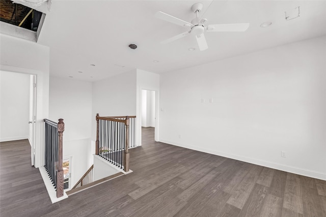 empty room featuring ceiling fan and dark hardwood / wood-style floors