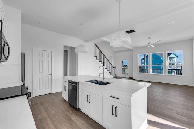 kitchen featuring white cabinetry, sink, stainless steel dishwasher, an island with sink, and pendant lighting