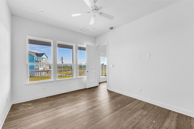 empty room featuring hardwood / wood-style floors and ceiling fan