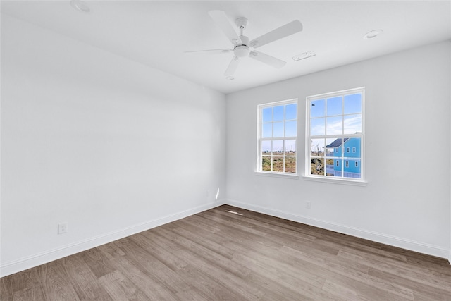 empty room featuring ceiling fan and hardwood / wood-style flooring