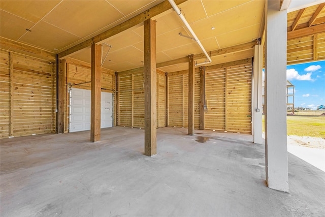 interior space featuring concrete floors and wooden walls