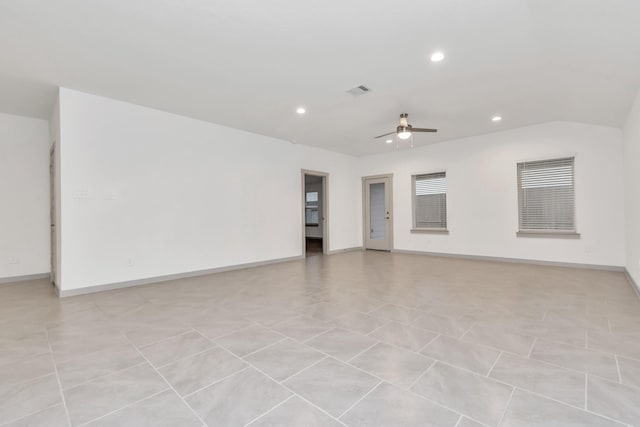 tiled spare room with ceiling fan